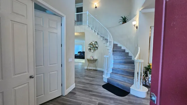 a view of entryway and gallery with wooden floor