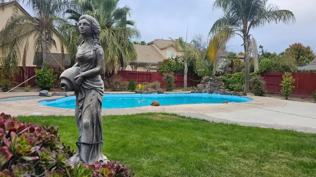a front view of multi story residential apartment building with yard and sign board