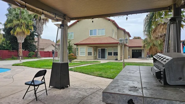 a front view of a house with a yard table and chairs
