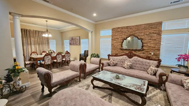 a living room with furniture and a large mirror