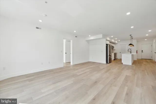 a view of a kitchen with a refrigerator and a window