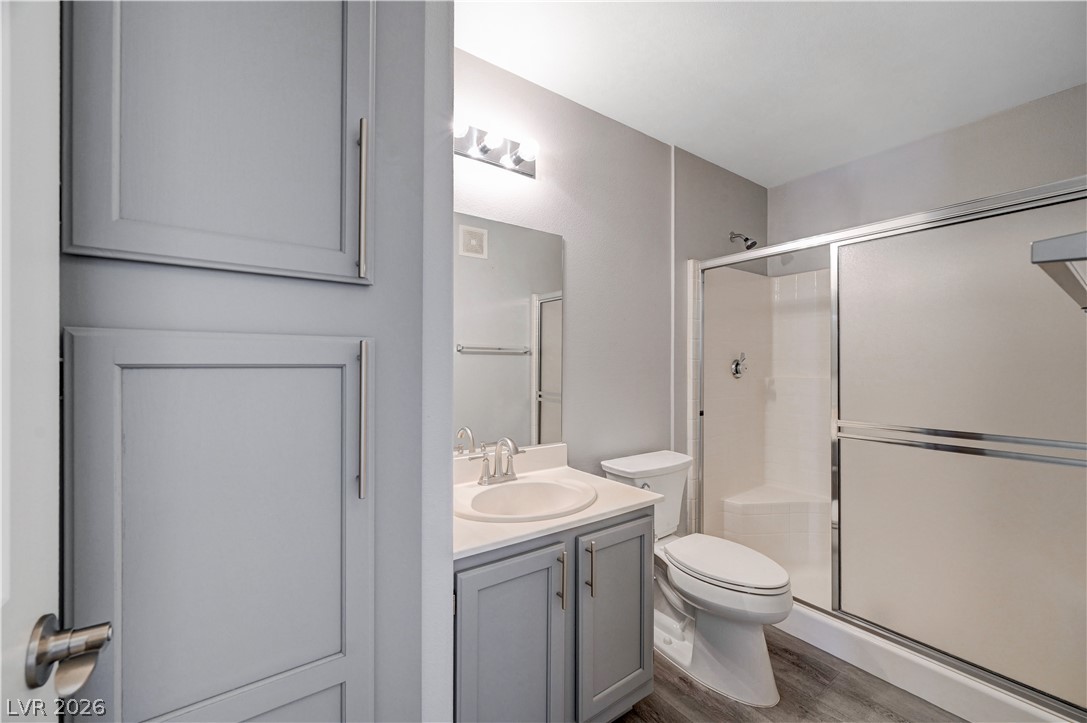 3425 East Russell Road, Unit 223 Las Vegas, NV 89120 - Photo 32 of 47 A well-appointed bathroom with a modern vanity, a sleek toilet, and a convenient shower stall with sliding glass doors.