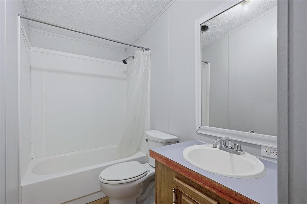 150 Gilbreath Road Sadler, TX 76264 - Photo 22 of 34 a bathroom with a sink toilet and shower