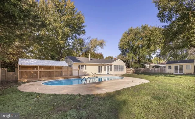 a view of a house with swimming pool and porch