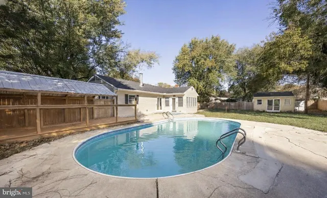 a view of a house with swimming pool and sitting area