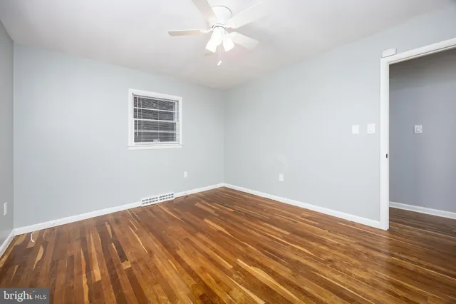 a bathroom with a sink a toilet a window and vanity
