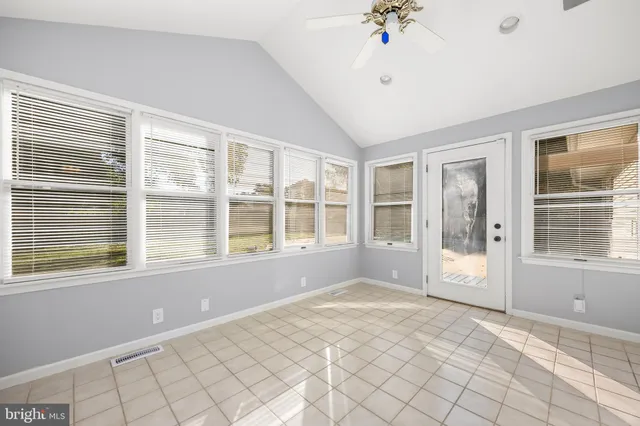a view of a room with wooden floor and windows