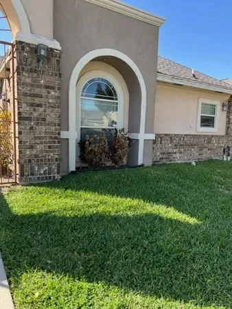 a front view of a house with garden