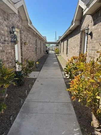 a pathway of a house with wooden fence