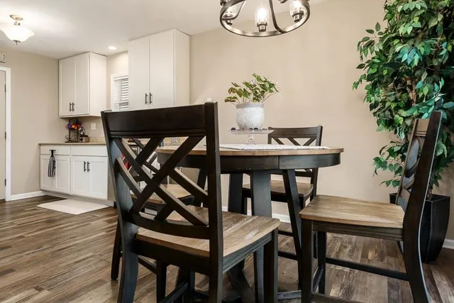a view of a dining room with furniture and wooden floor