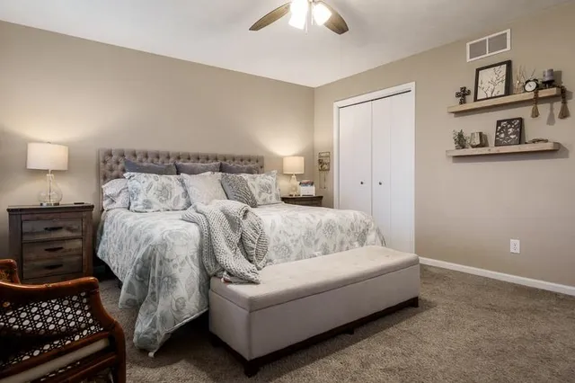 a bed room with a bed and a lamp