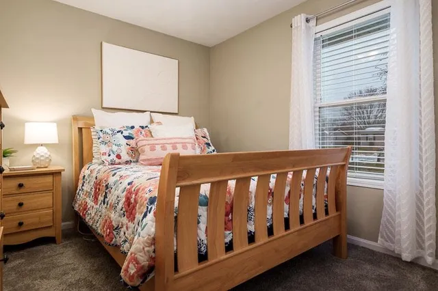 a bedroom with a bed with window