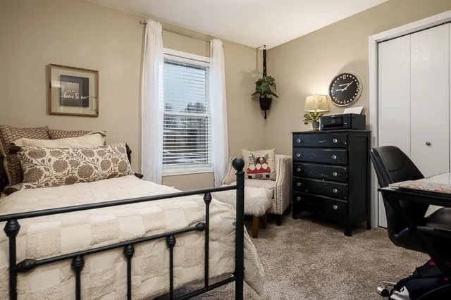 a bedroom with a bed and a dresser