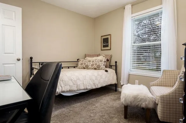 a bedroom with a bed and a window