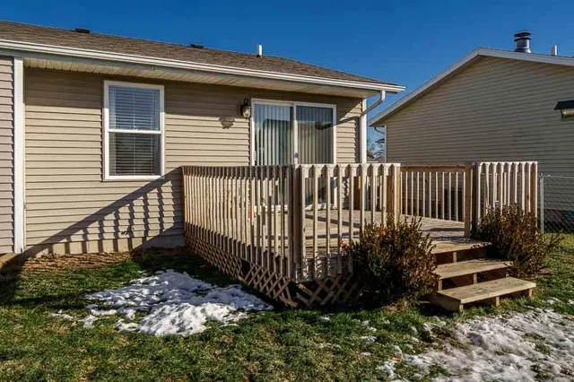 a view of a house with wooden fence
