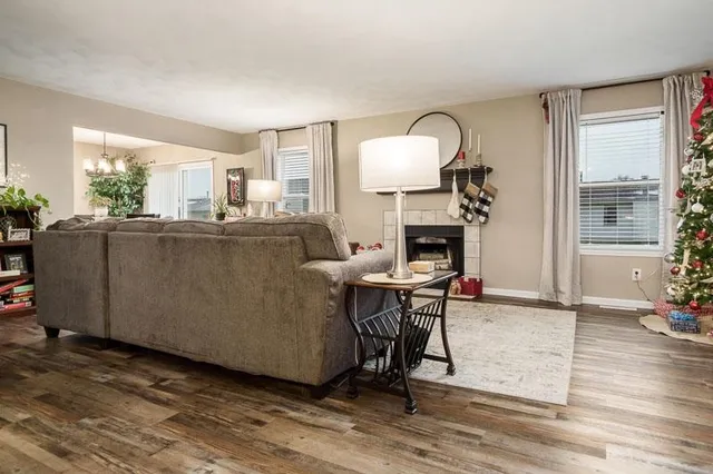 a living room with furniture a fireplace and a table
