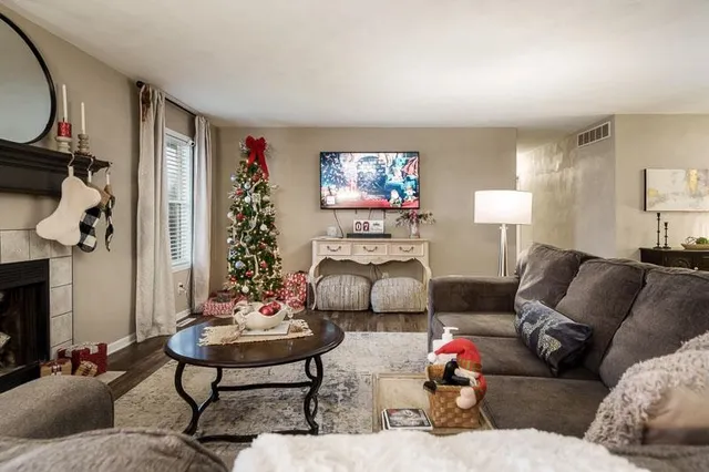 a living room with furniture a rug and a fireplace