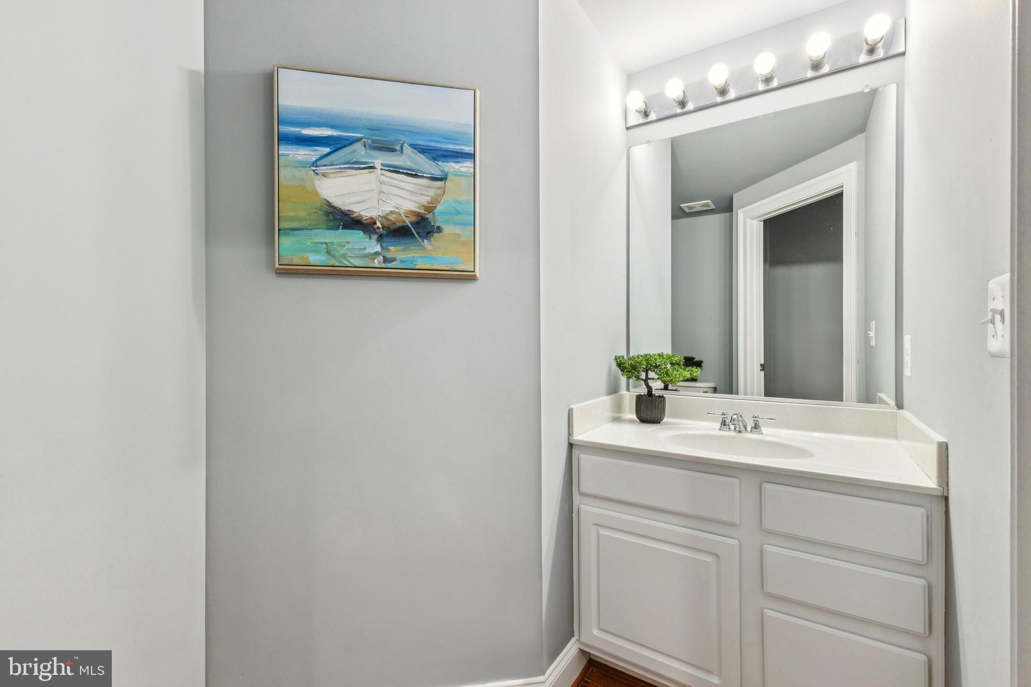 16363 Rusty Rudder Drive Woodbridge, VA 22191 - Photo 13 of 40 a bathroom with a sink and a mirror