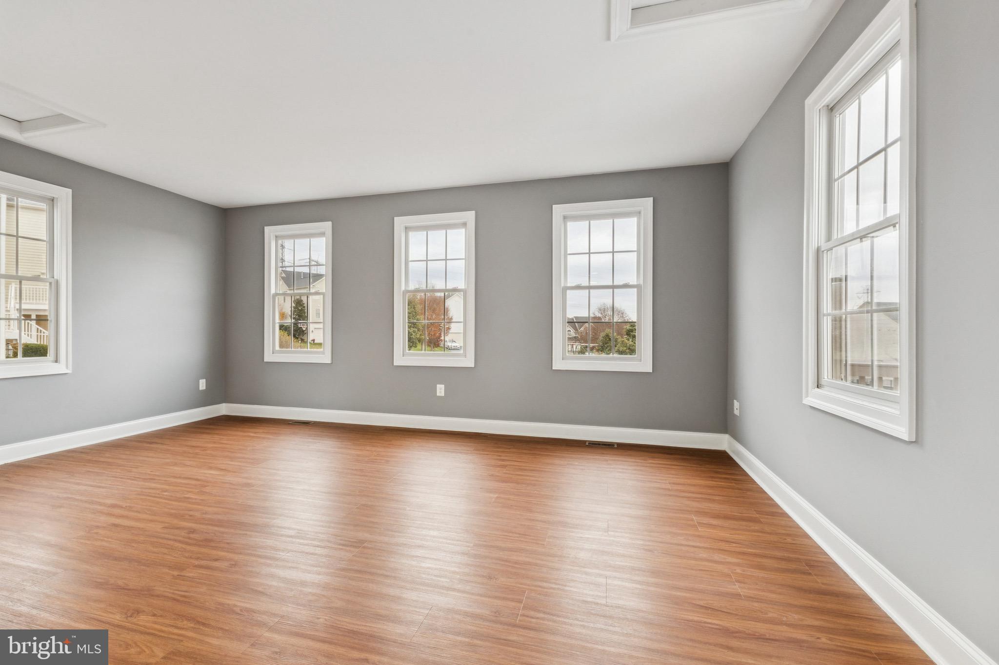 16363 Rusty Rudder Drive Woodbridge, VA 22191 - Photo 14 of 40 a view of an empty room with wooden floor and a window