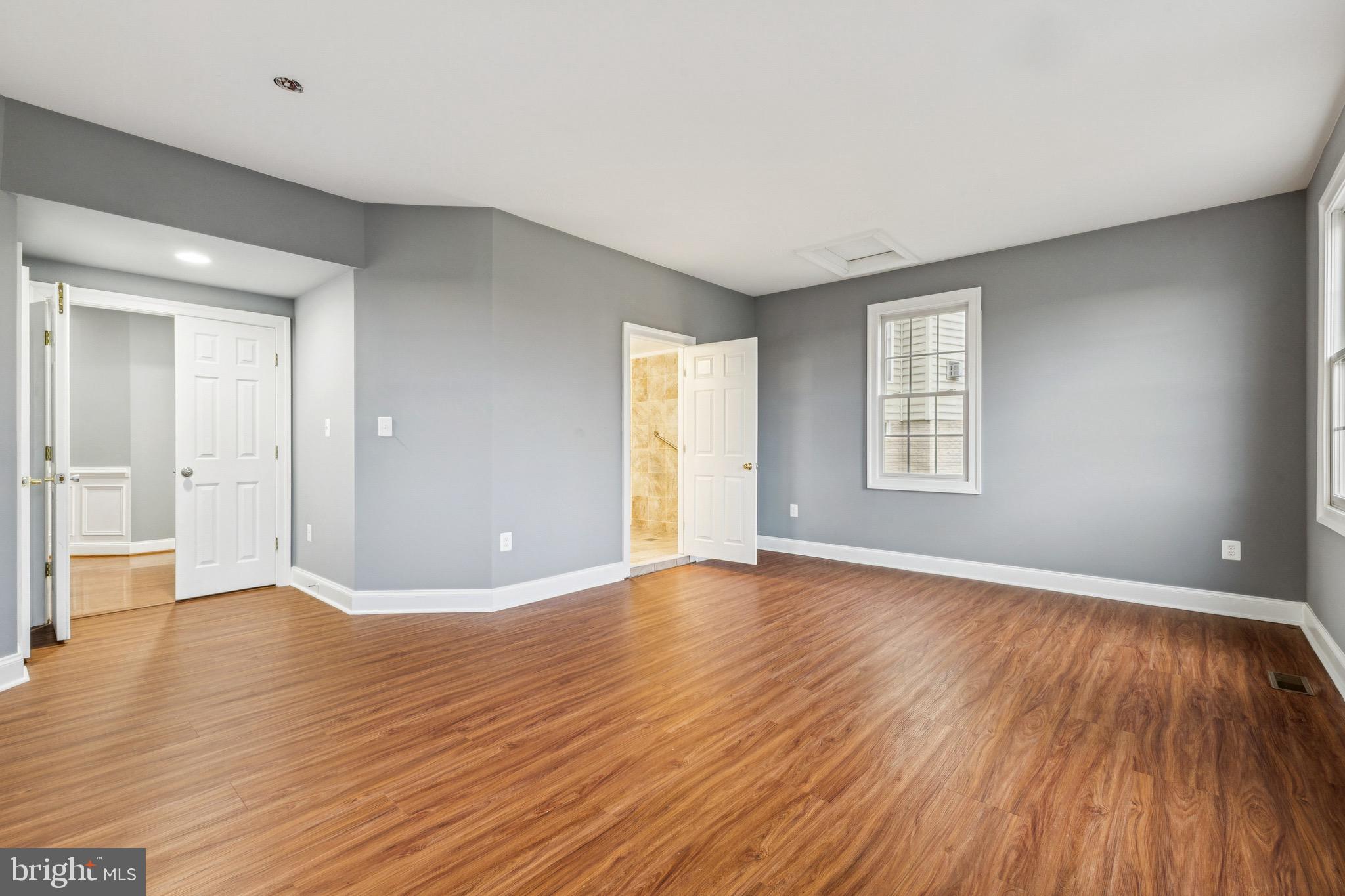 16363 Rusty Rudder Drive Woodbridge, VA 22191 - Photo 15 of 40 an empty room with wooden floor and windows