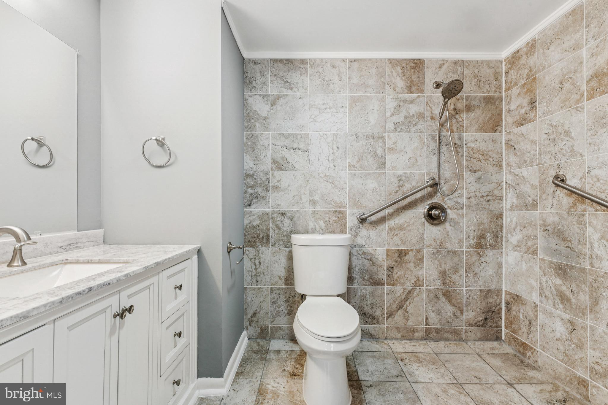 16363 Rusty Rudder Drive Woodbridge, VA 22191 - Photo 17 of 40 a bathroom with a granite countertop toilet a sink a shower and a mirror