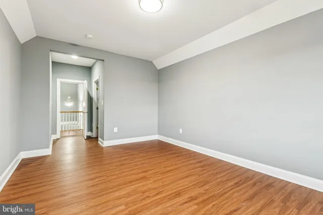 a view of an empty room and wooden floor