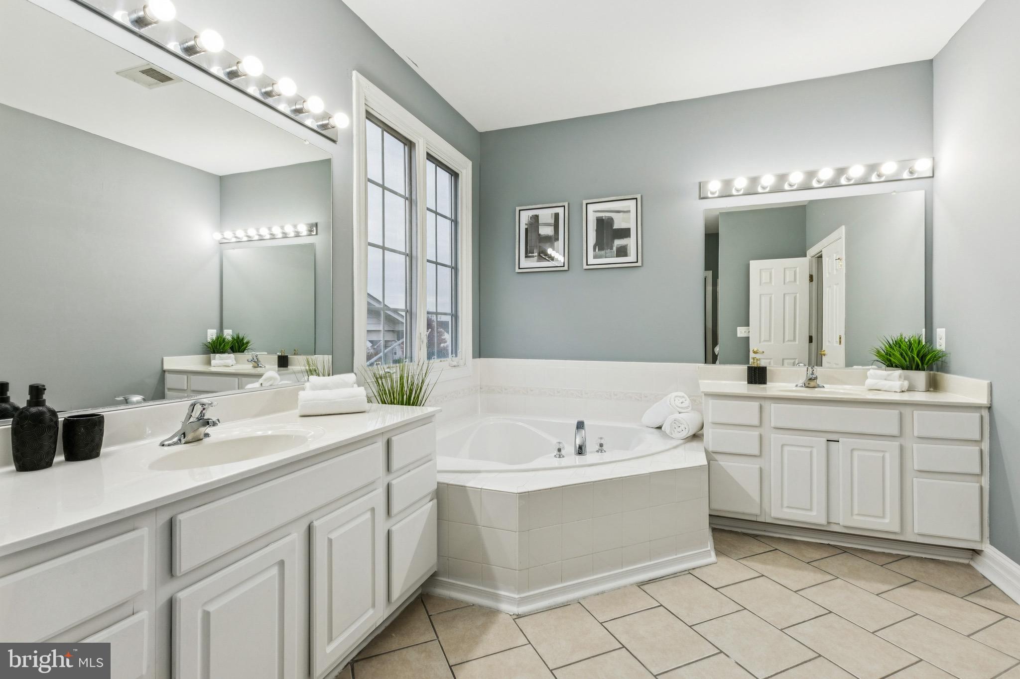 16363 Rusty Rudder Drive Woodbridge, VA 22191 - Photo 24 of 40 a bathroom with a double vanity sink mirror and bathtub