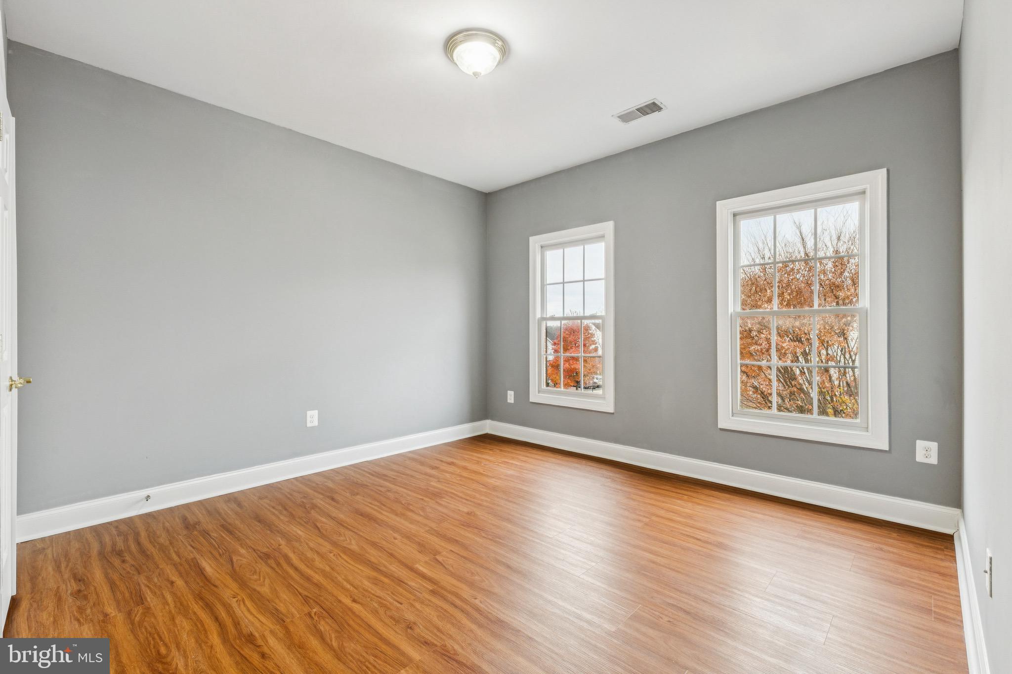 16363 Rusty Rudder Drive Woodbridge, VA 22191 - Photo 29 of 40 an empty room with wooden floor and windows