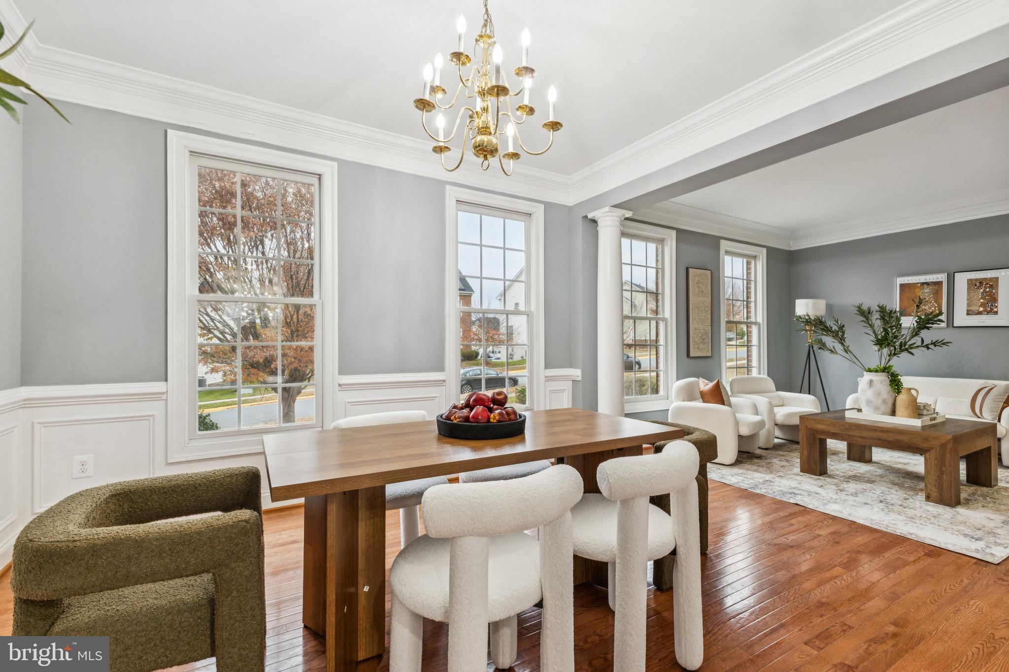 16363 Rusty Rudder Drive Woodbridge, VA 22191 - Photo 6 of 40 a dining room with wooden floor furniture and a chandelier