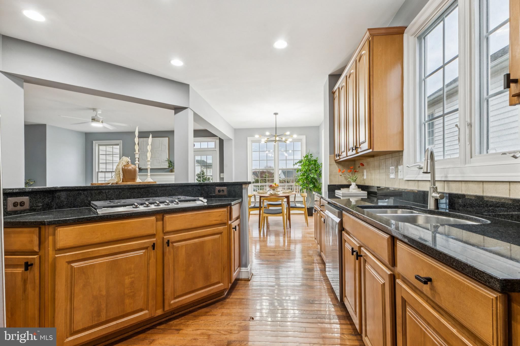 16363 Rusty Rudder Drive Woodbridge, VA 22191 - Photo 7 of 40 a large kitchen with stainless steel appliances granite countertop a stove a sink and a microwave