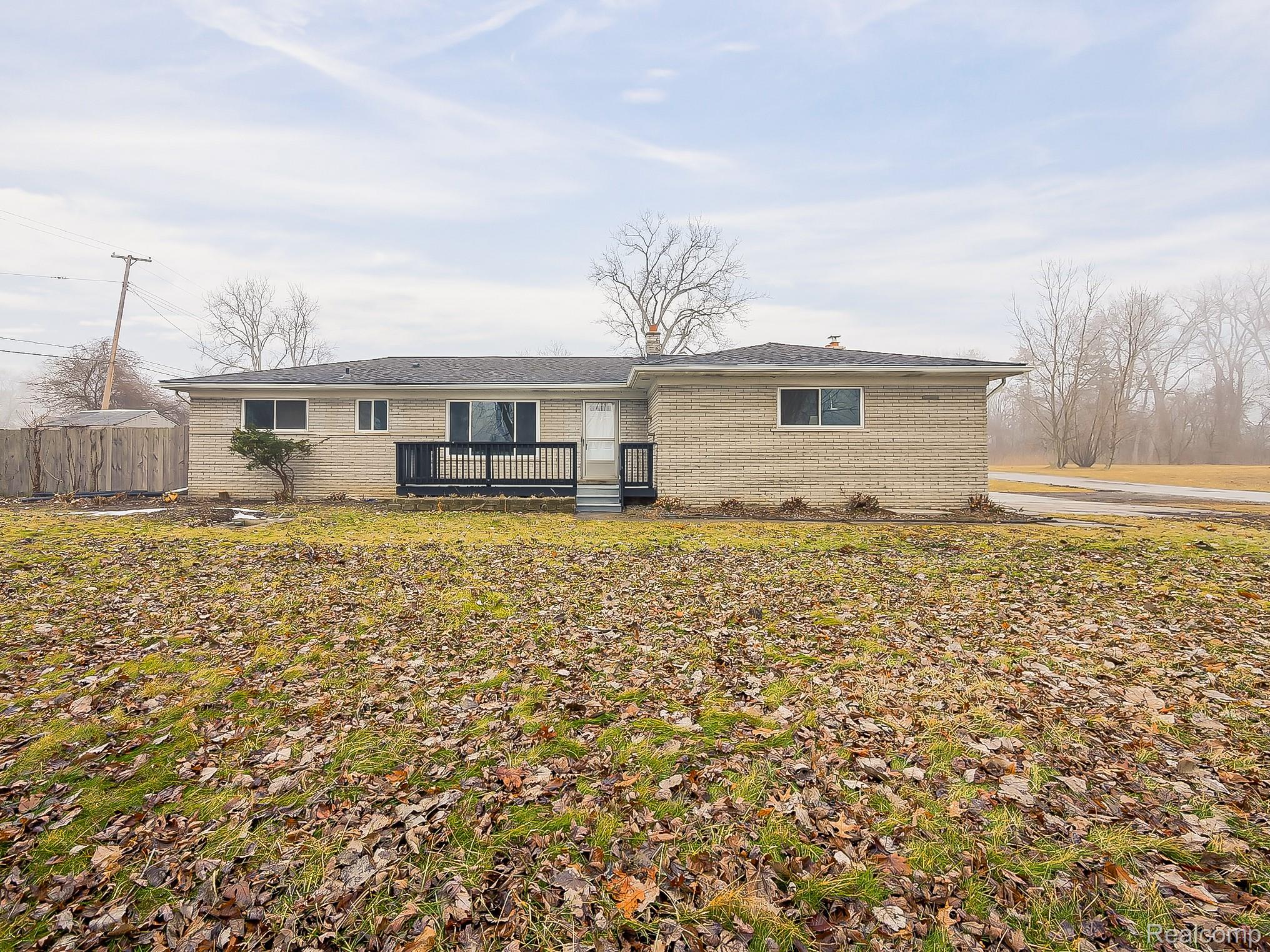 11780 Haggerty Road Belleville, MI 48111 - Photo 40 of 41 Back of house with a wooden deck and brick siding