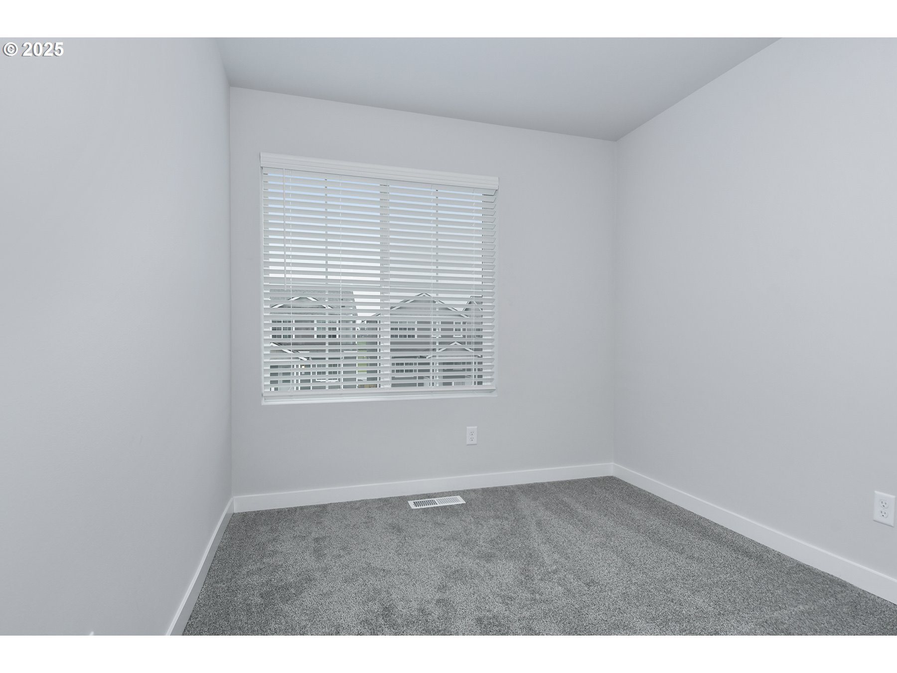 1375 Owl Avenue Woodburn, OR 97071 - Photo 17 of 20 a view of an empty room with wooden floor and a window