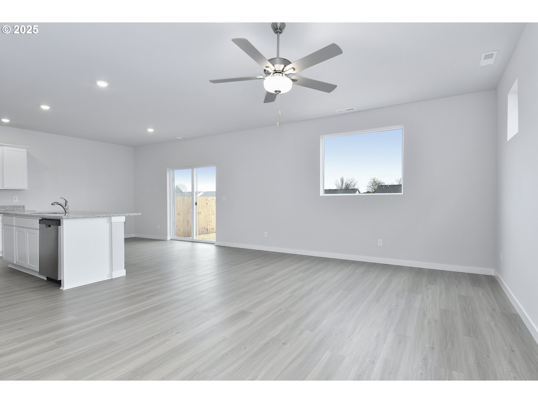 1375 Owl Avenue Woodburn, OR 97071 - Photo 4 of 20 a view of an empty room with a window and wooden floor