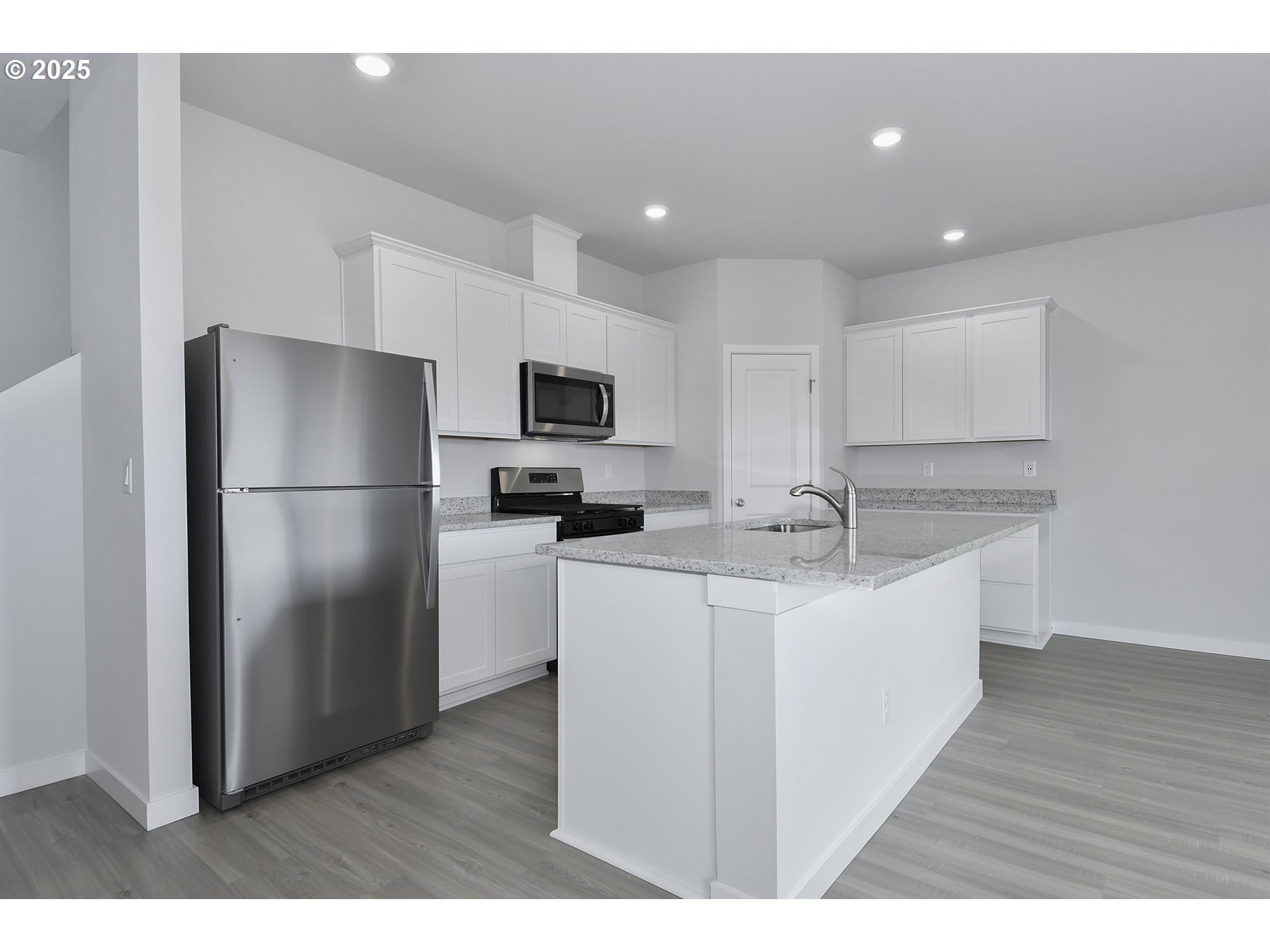 1375 Owl Avenue Woodburn, OR 97071 - Photo 5 of 20 a kitchen with kitchen island a sink stainless steel appliances and refrigerator