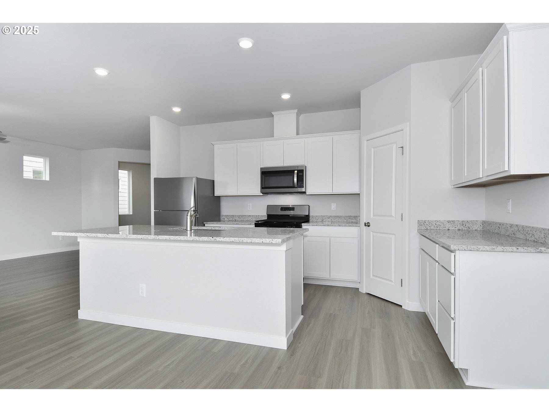 1375 Owl Avenue Woodburn, OR 97071 - Photo 6 of 20 a kitchen with stainless steel appliances granite countertop a stove a sink a refrigerator and white cabinets