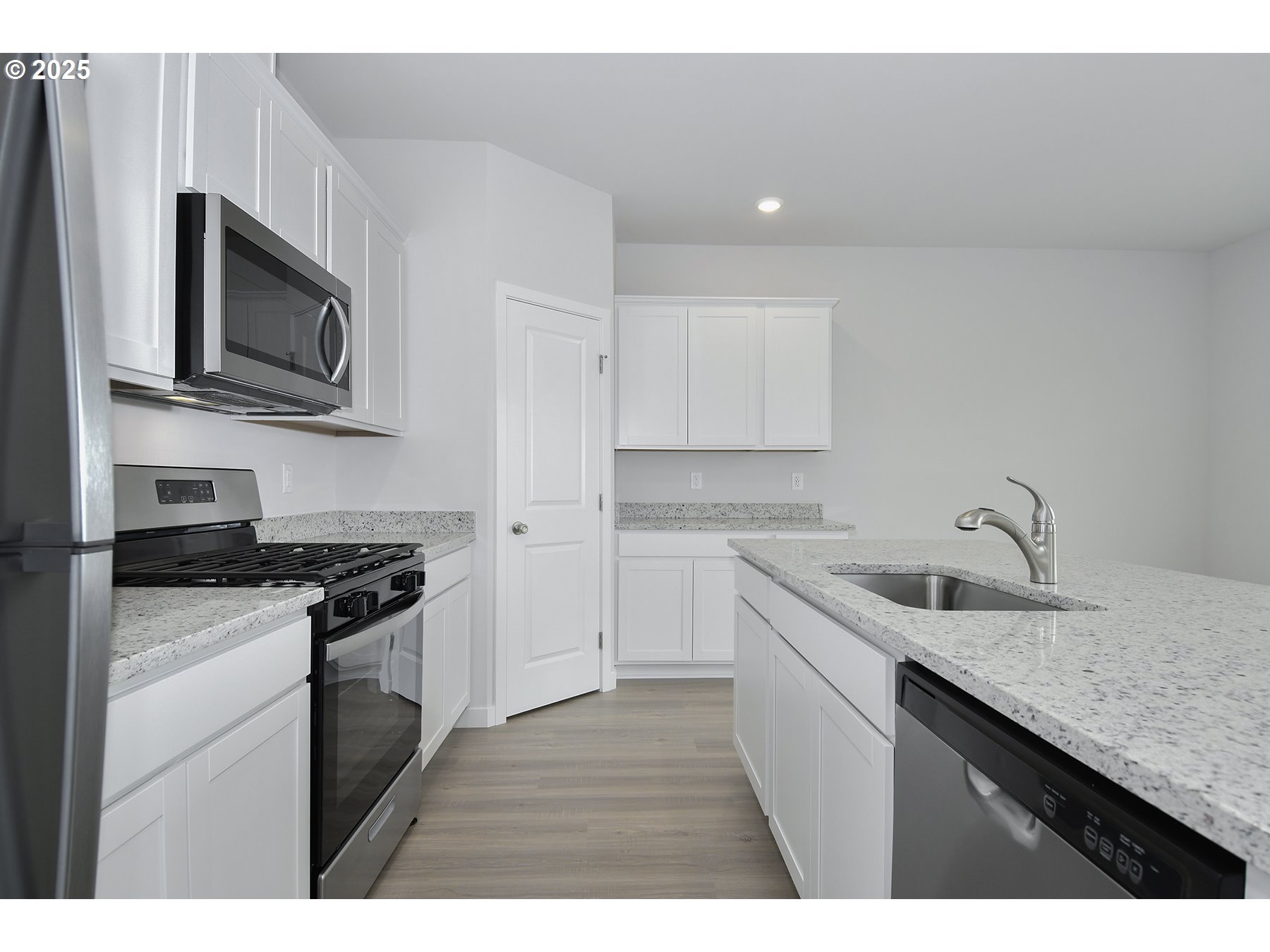 1375 Owl Avenue Woodburn, OR 97071 - Photo 8 of 20 a kitchen with stainless steel appliances granite countertop a sink stove and microwave