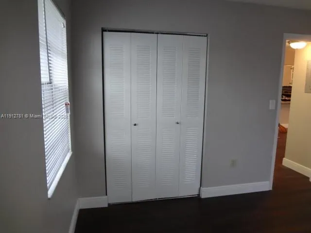 a view of wooden floor and windows in a room
