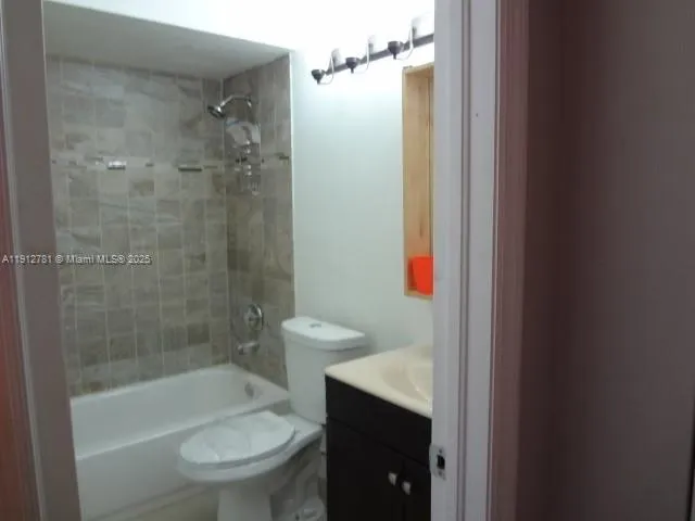 a bathroom with a shower a toilet and sink