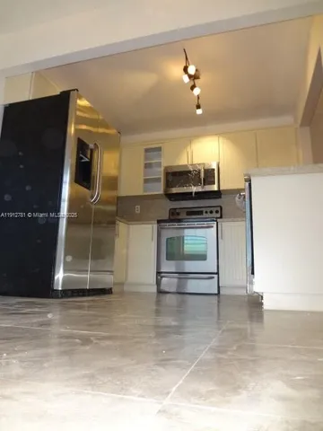 a kitchen with a sink and a stove top oven