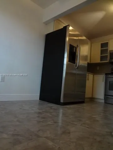 a view of a refrigerator in kitchen