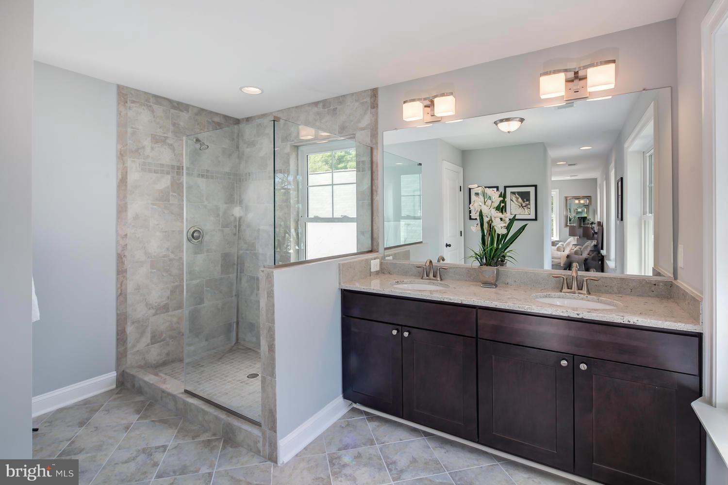 859 Venable Place Northwest Washington, DC 20012 - Photo 19 of 30 a bathroom with a shower sink and mirror