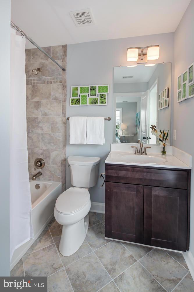 859 Venable Place Northwest Washington, DC 20012 - Photo 22 of 30 a bathroom with a sink toilet and mirror