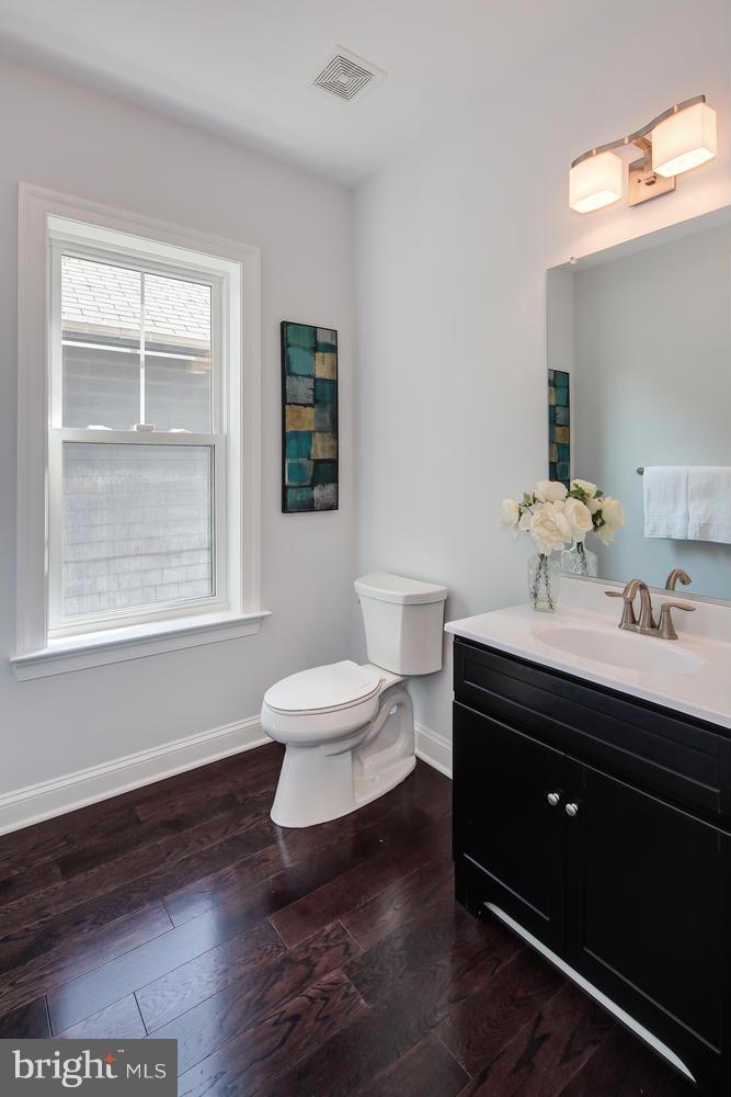859 Venable Place Northwest Washington, DC 20012 - Photo 8 of 30 a bathroom with a sink a toilet and a window