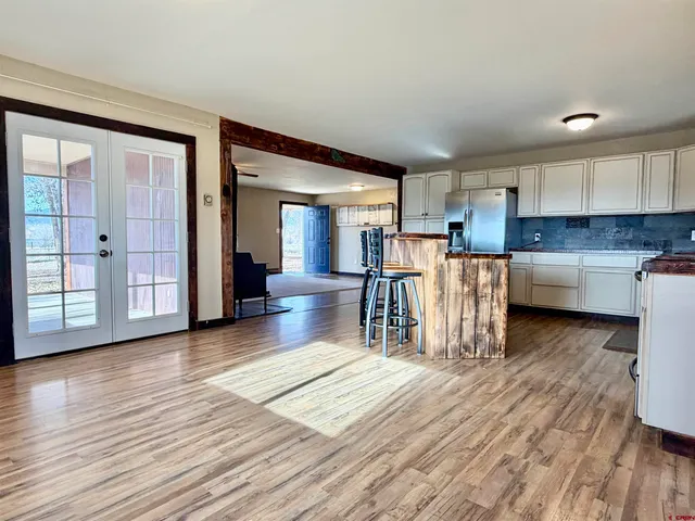 a view of a kitchen with furniture and wooden floor