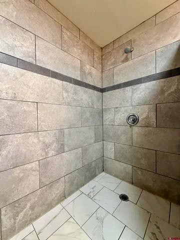 a view of a room with racks on the wall and a window