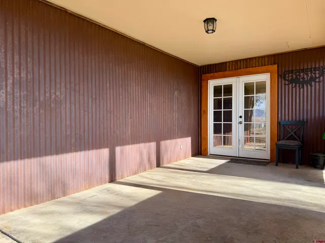 a view of a house with a yard and covered with trees