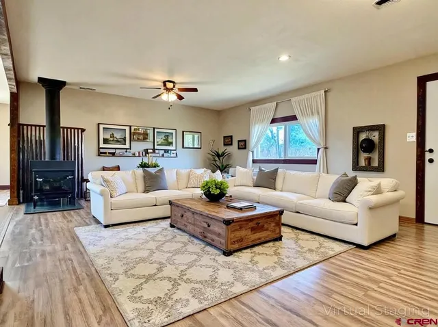 a living room with furniture and a chandelier