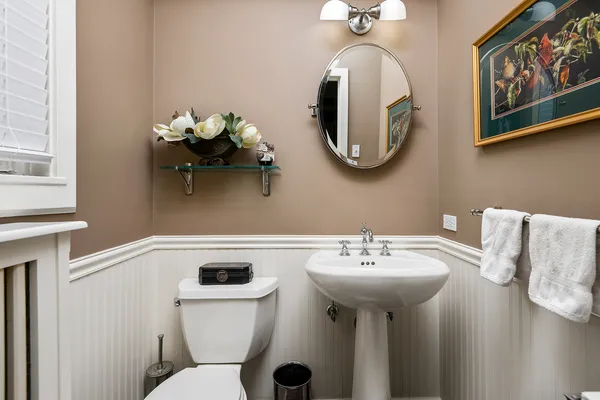 a bathroom with a sink mirror and toilet