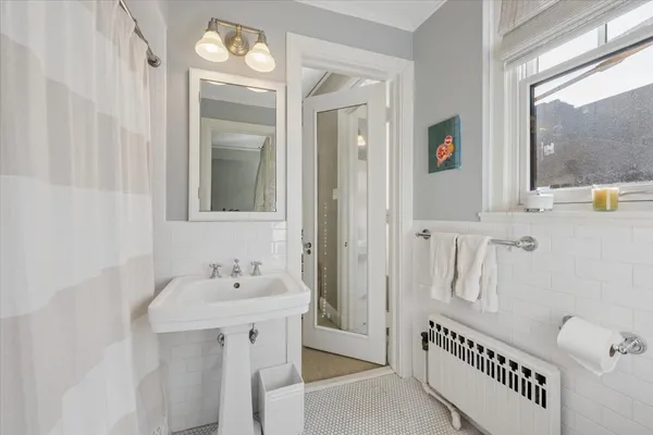 a bathroom with a sink a mirror and a window