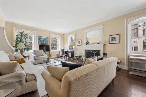 a living room with furniture large window and a fireplace